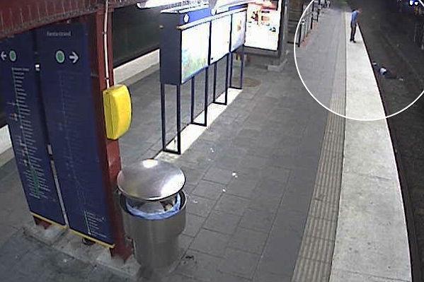 Imaginile care au scandalizat Suedia! Un hoţ îşi buzunăreşte victima, pe care o abandonează pe şinele de tren