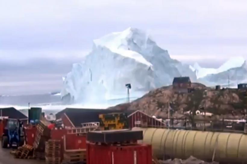 VIDEO - Spectacol periculos în Groenlanda. Un iceberg uriaș a trecut la mustață pe lângă un sat