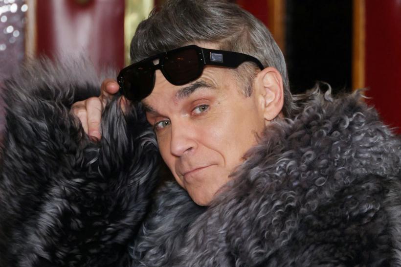 Robbie Williams face istorie. Noul album depășește Beatles în topurile din Marea Britanie