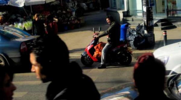 pe aripile vantului conducand un scuter