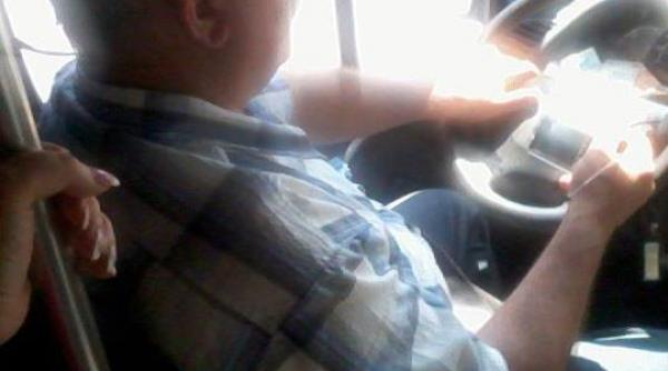 foto soferul unui microbuz plin cu oameni conduce cu coatele si urmareste filme la volan