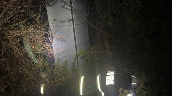 Șofer scos din râpă de pompieri, după ce a căzut cu tot cu mașină